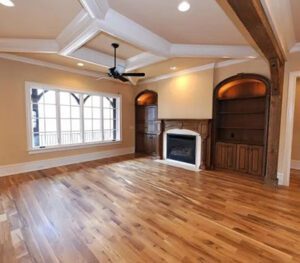 A living room with hard wood floors and fireplace.