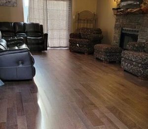 A living room with hard wood floors and furniture.
