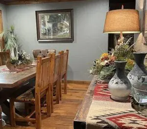 A dining room with wooden table and chairs