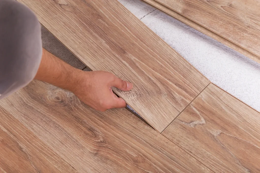 A person is sanding the floor of their home.