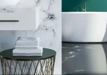 A bathroom with marble walls and floors, and a tub.